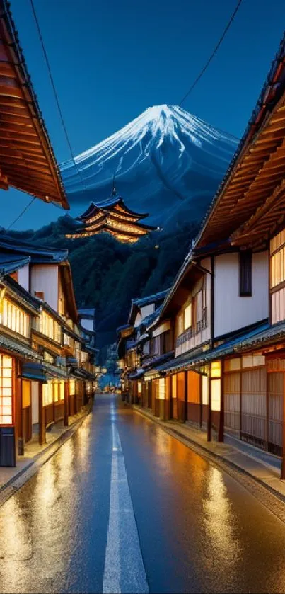 Japanese street leading to a snow-capped mountain at night.