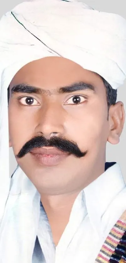 Man wearing traditional Indian turban in vibrant attire.