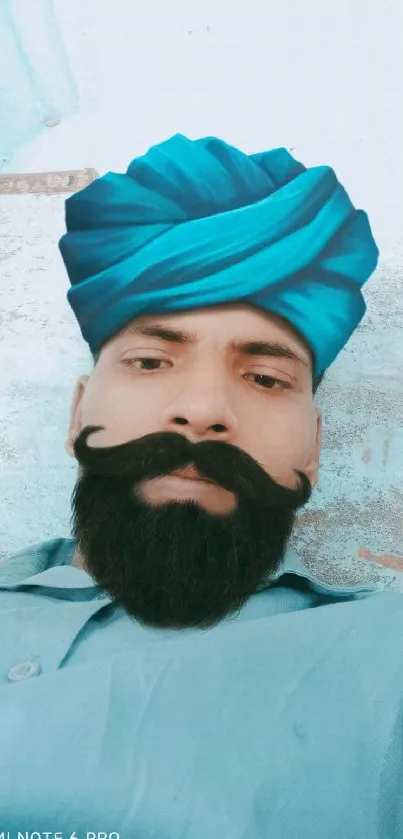 Man wearing a turquoise turban and traditional attire.