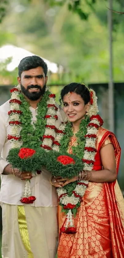 Traditional wedding couple with garlands.