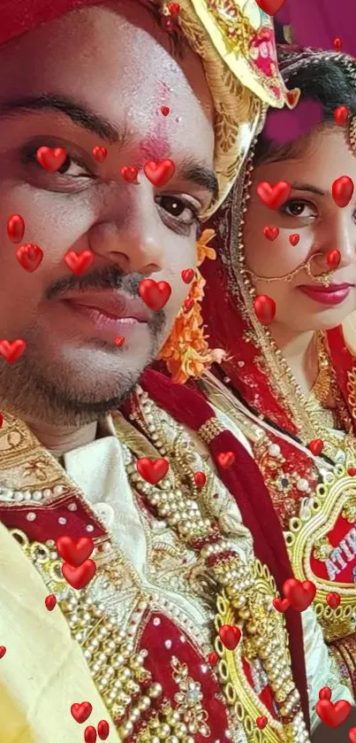 Vibrant wedding couple in traditional attire with red hearts.