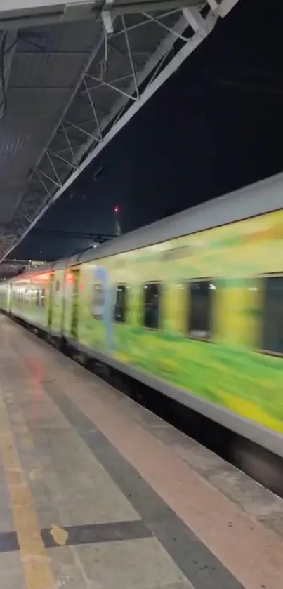 A vibrant green train speeding through a night station.