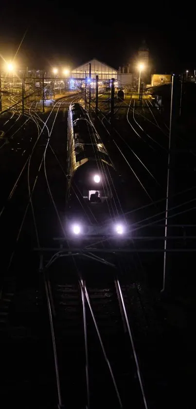 A night train with bright lights on dark tracks.