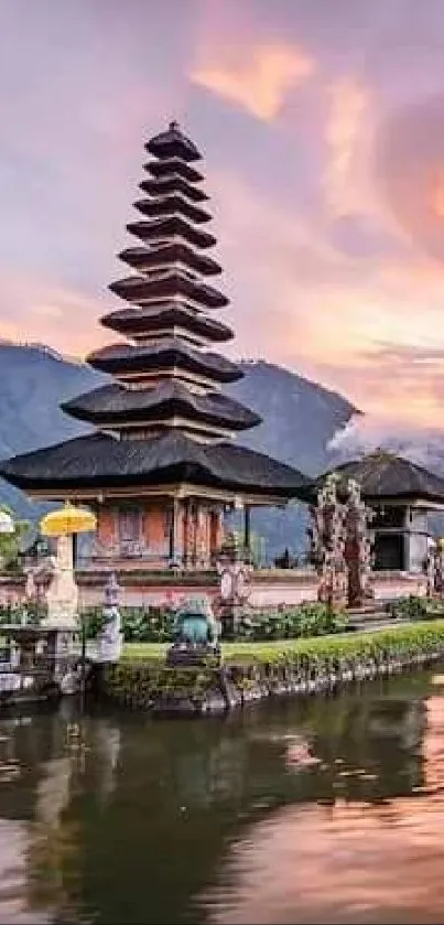 Bali temple at sunset with reflection on water.