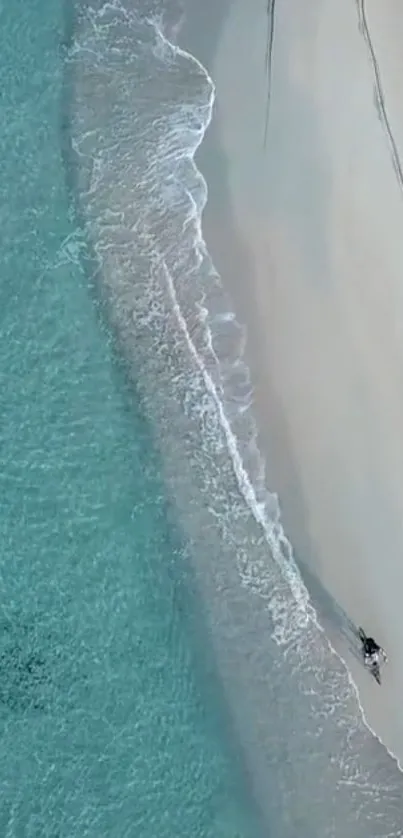 Aerial view of tranquil turquoise beach with gentle waves.