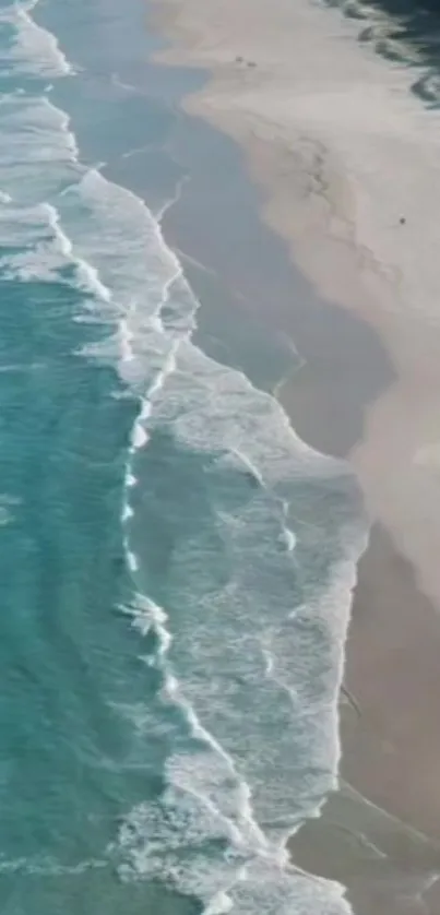 Aerial view of a turquoise ocean and sandy beach.