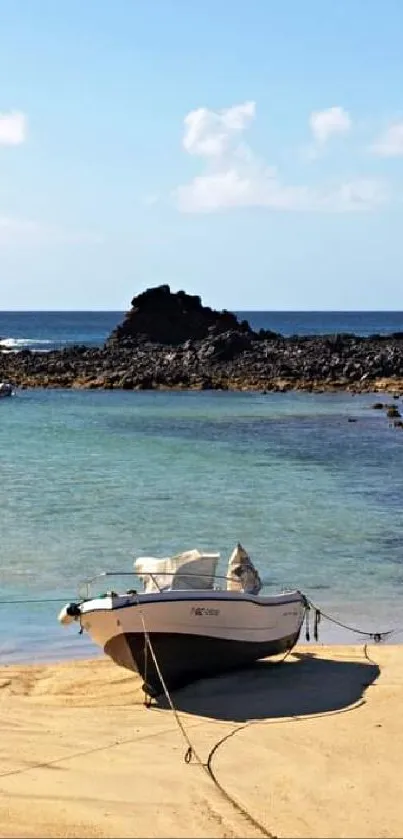 A boat on golden sand by a tranquil blue sea under a clear sky.