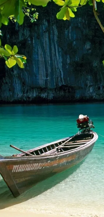 Wooden boat on turquoise beach waters under green foliage.