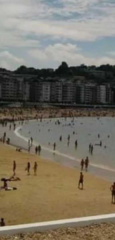 Beach cityscape with people enjoying the shore and skyline in the background.