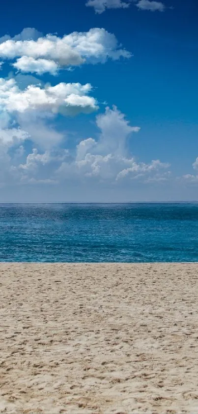 Tranquil beach view with blue sky and ocean horizon.