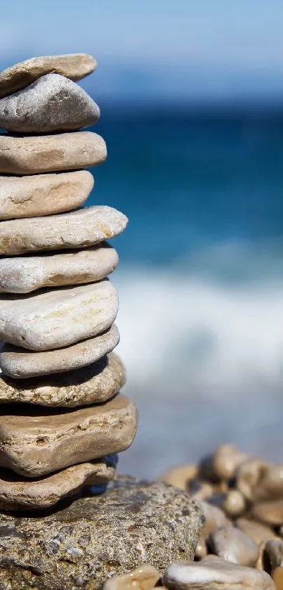 Stack of stones on a tranquil beach with the ocean in the background.