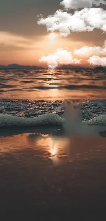 Mobile wallpaper of a serene beach at sunset with soft ocean waves.