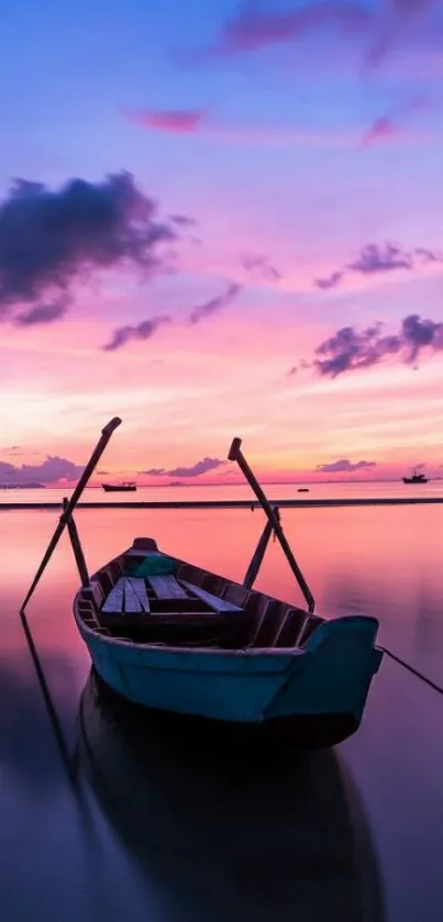 Tranquil boat on calm water during a stunning pink and purple sunset.