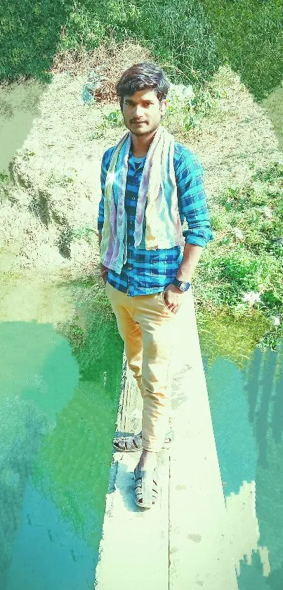 Man standing on a scenic bridge with lush greenery.