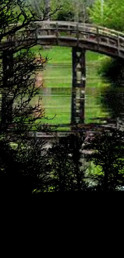 Serene wallpaper with bridge over calm river and lush green surroundings.