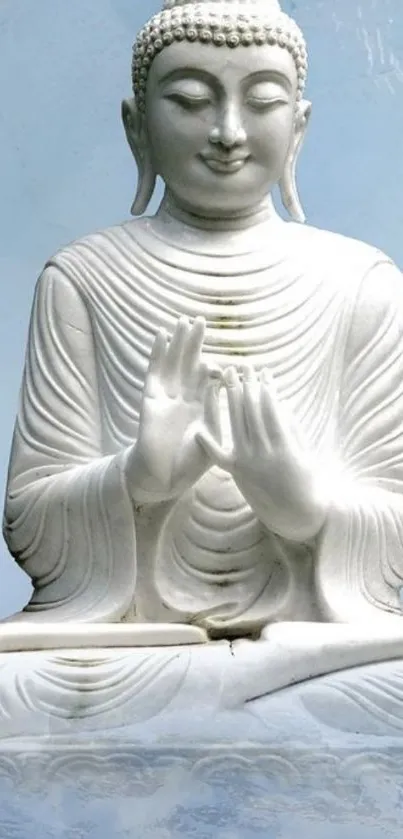 Serene Buddha statue against a sky blue background.