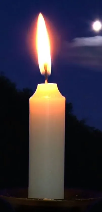 Candle flame against dark night sky with moon.