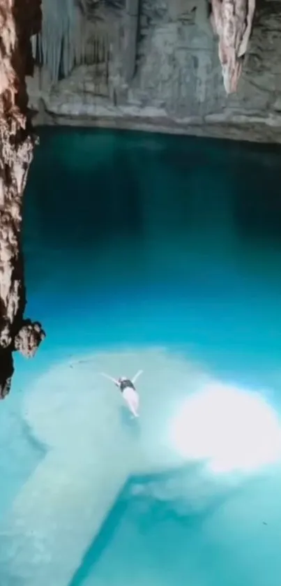 Person swimming in a tranquil cave with turquoise blue water.