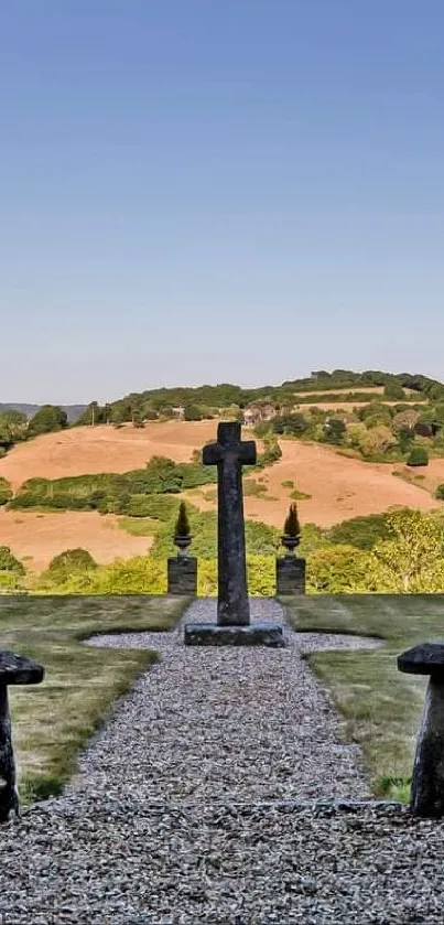 Serene countryside landscape wallpaper with trees and cross.