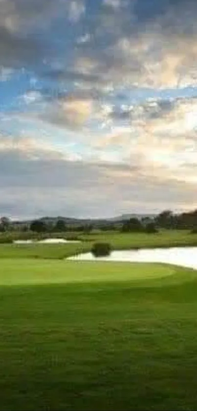 Serene golf course under a vibrant sunset sky.