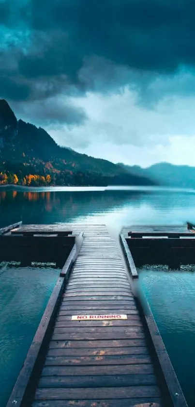 Tranquil dock on a misty lake with dramatic clouds.