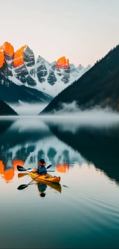 Kayaker on a serene lake with mountain reflections at sunrise.