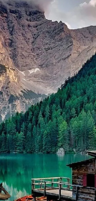 Mountain lake view with green forests and calm water.