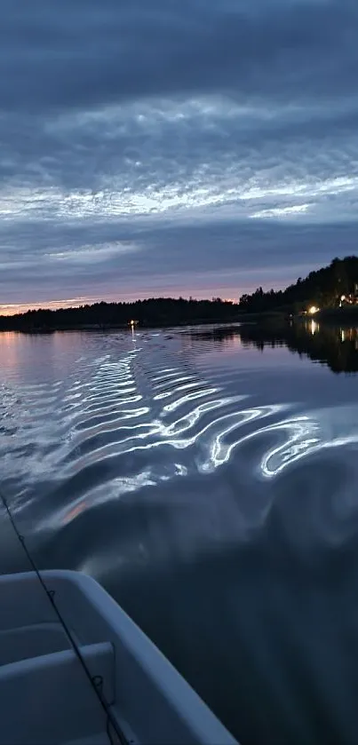 Tranquil lake at twilight with serene sunset.