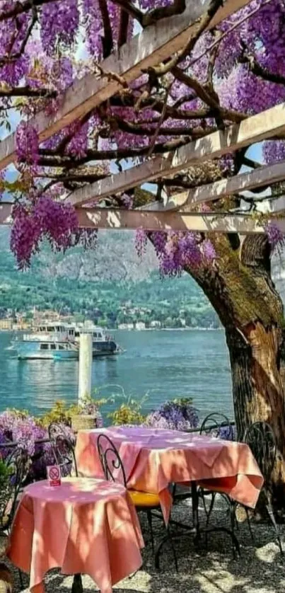 Mobile wallpaper of a tranquil lakeside terrace with vibrant purple wisteria.