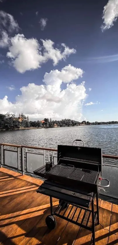 Mobile wallpaper of a BBQ grill on a wooden deck by a serene lake with a cloudy sky.