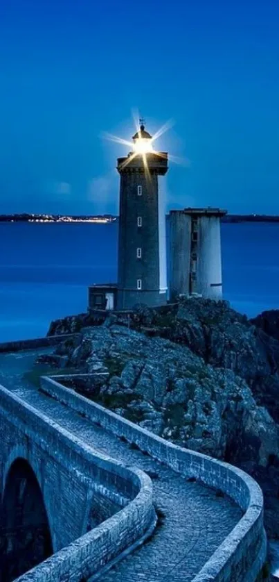 Lighthouse at dusk with a deep blue sky and ocean creating a serene atmosphere.