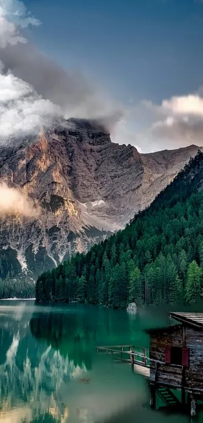 Tranquil mountain lake with a cabin and forest reflection.