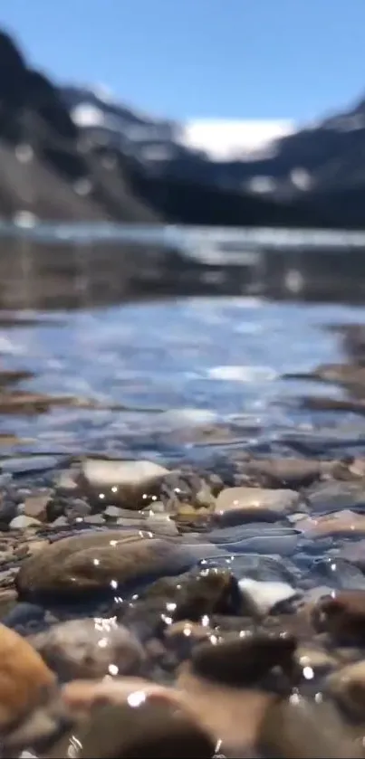 Crystal clear mountain lake with rocky shoreline in a serene landscape.