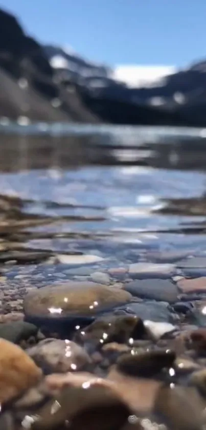 Calm mountain lake with clear reflections and rocky shore.