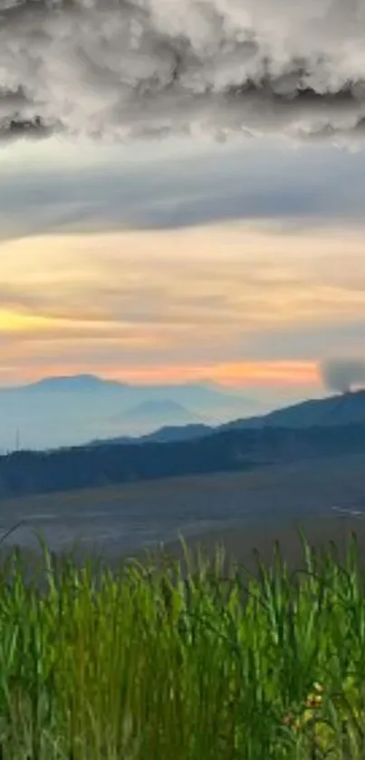 Tranquil sunset view over mountains and green grass.