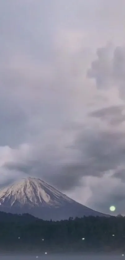 Majestic mountain under a cloudy sky in serene landscape.