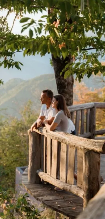 Couple enjoying tranquil mountain view on a wooden deck.