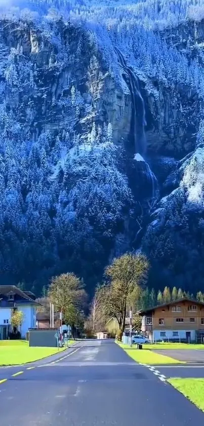 Mobile wallpaper of a serene mountain village with snowy cliffs and greenery.