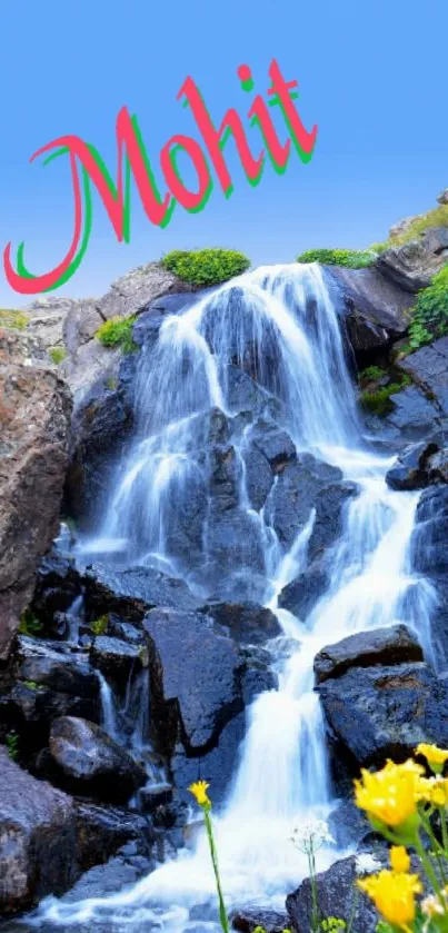 Mountain waterfall with vibrant flowers and blue sky.