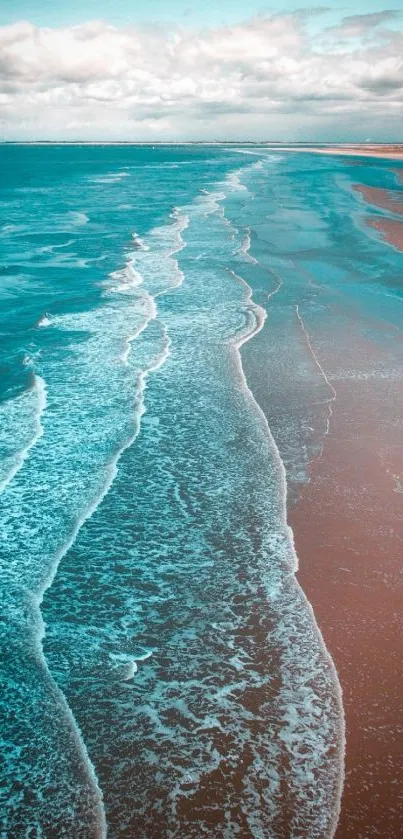 Aerial view of serene ocean waves with a cloudy sky background.