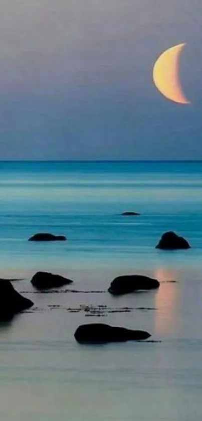 Ocean view with crescent moonrise, tranquil evening scene.