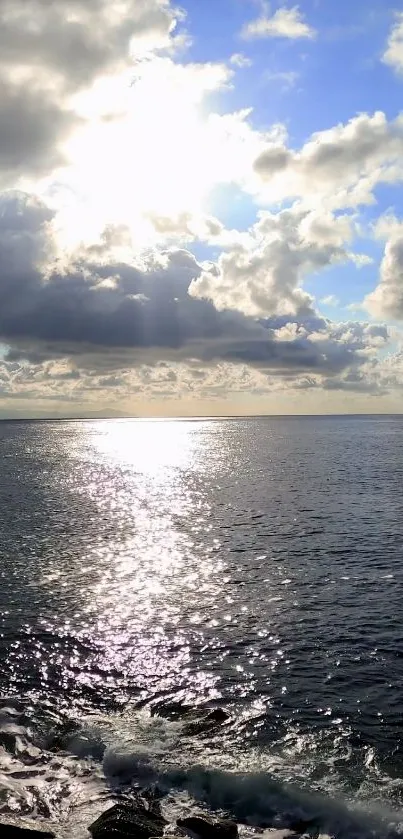 Ocean sunrise with clouds and sunlight reflecting on water.