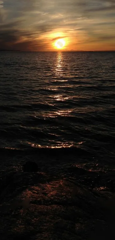Stunning sunset over ocean with golden reflections creating a serene ambiance.