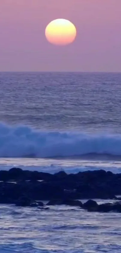 Purple ocean sunset with waves and pink sky.