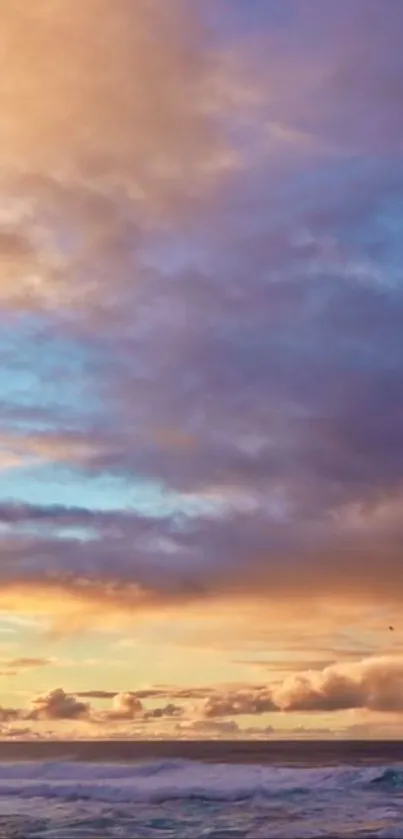 Tranquil ocean sunset with colorful clouds.