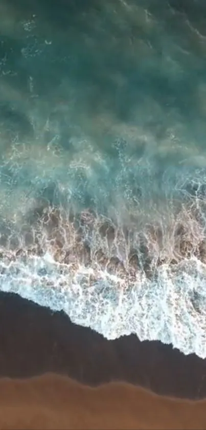 Aerial view of ocean waves meeting sandy shore, perfect for a calming wallpaper.