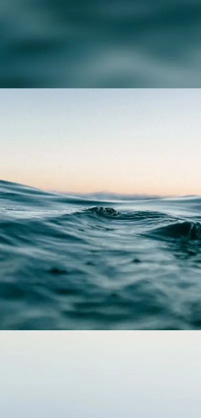 Tranquil teal ocean waves with subtle sunset sky.