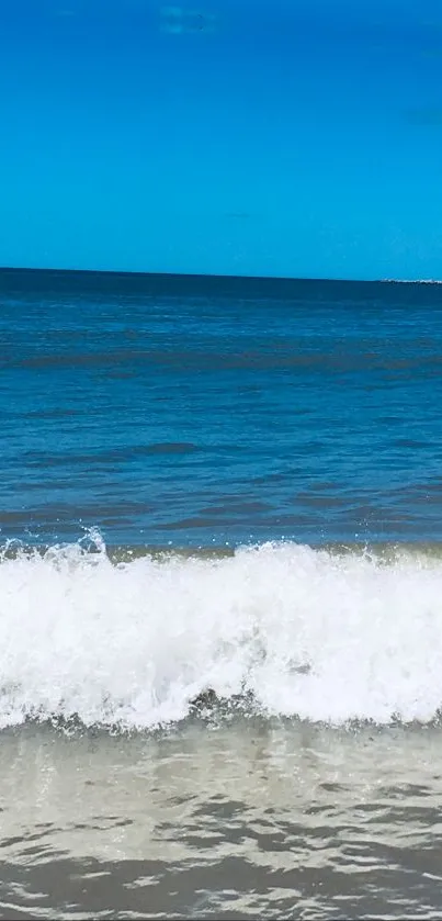 Scenic mobile wallpaper of ocean waves with blue sky and white surf.