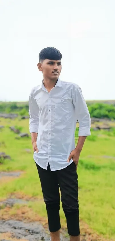 Young man standing on a nature path in lush greenery.