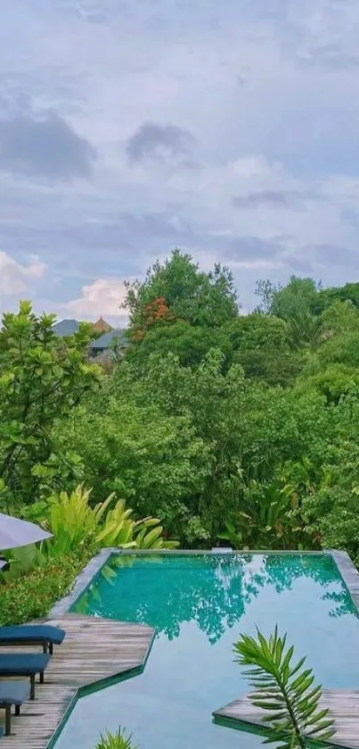 Tranquil tropical poolside with lush greenery and vibrant sky.